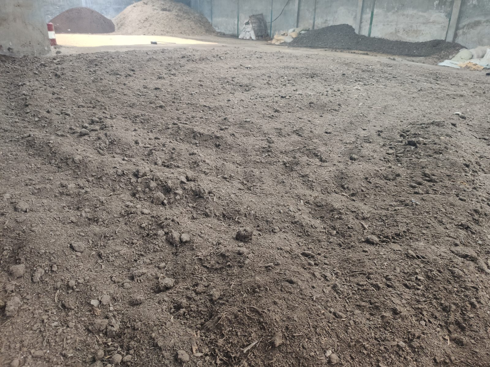 Windrow composting area with self-propelled compost turner